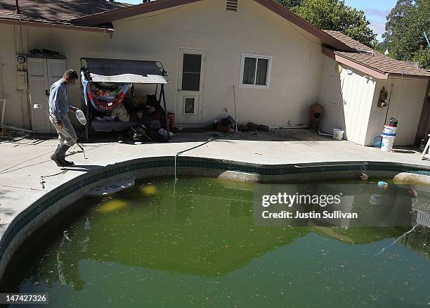 Contra Costa County Mosquito and Vector Control District technician David Wexler prepares to release Gambusia affinis, more commonly known as...