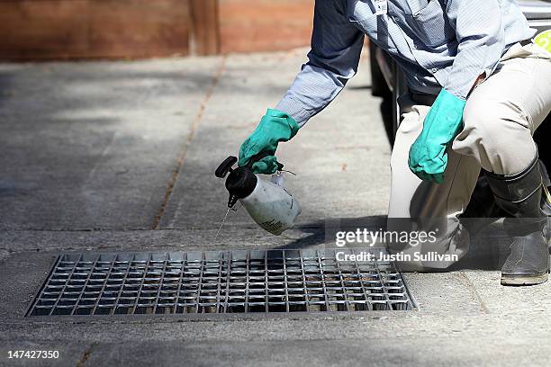 Contra Costa County Mosquito and Vector Control District technician David Wexler sprays BVA Larvacide Oil on standing water in a catch basin on June...