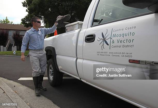 Contra Costa County Mosquito and Vector Control District technician David Wexler puts his boots in his truck before inspecting a creek on June 29,...