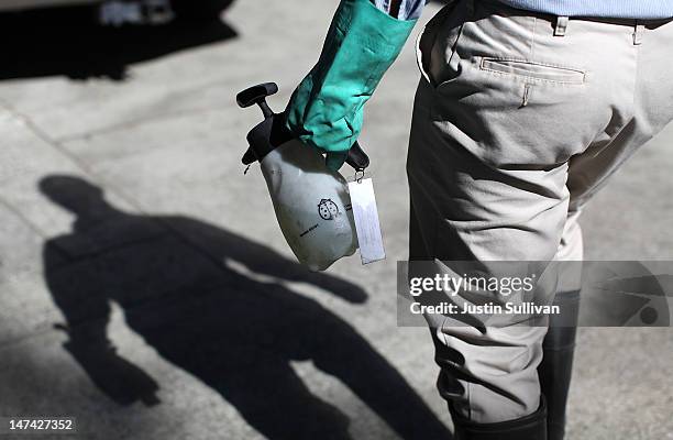 Contra Costa County Mosquito and Vector Control District technician David Wexler carries a container of BVA Larvacide Oil before spraying a catch...