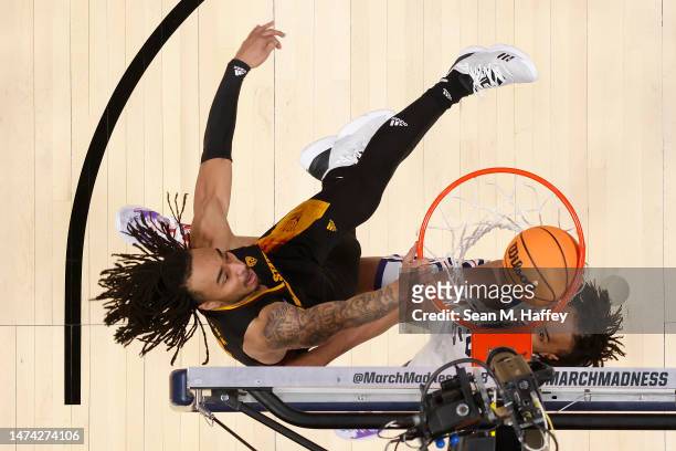 Frankie Collins of the Arizona State Sun Devils dunks the ball against Chuck O'Bannon Jr. #5 of the TCU Horned Frogs during the second half in the...