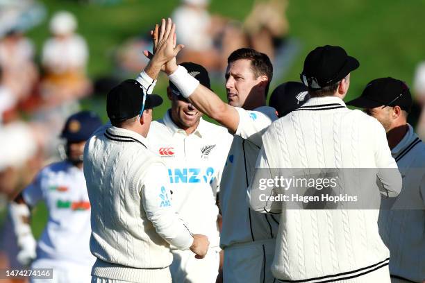 Matt Henry of New Zealand celebrates with teammates after taking the wicket of Oshada Fernando of Sri Lanka during day two of the Second Test Match...