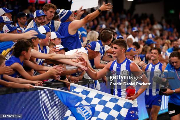 Harry Sheezel of the Kangaroos celebrates with fans after winning the round one AFL match between North Melbourne Kangaroos and West Coast Eagles at...