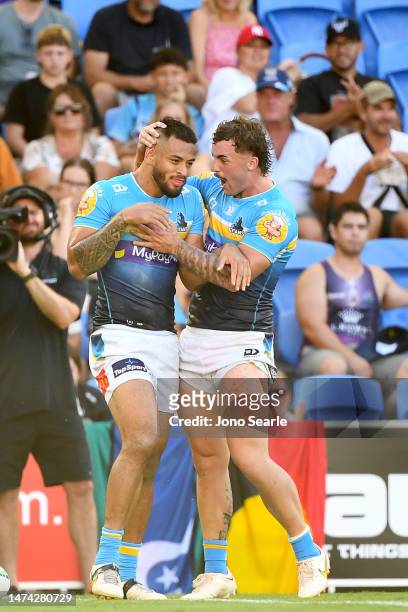 Phillip Sami and Aaron Schoupp of the Titans celebrate a try during the round three NRL match between the Gold Coast Titans and the Melbourne Storm...