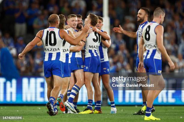 Kangaroos players celebrate winning the round one AFL match between North Melbourne Kangaroos and West Coast Eagles at Marvel Stadium, on March 18 in...