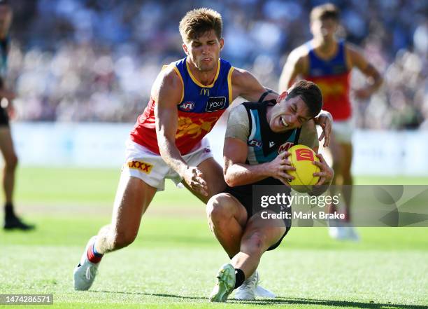 Zak Butters of Port Adelaide competes with Zac Bailey of the Lions during the round one AFL match between Port Adelaide Power and Brisbane Lions at...