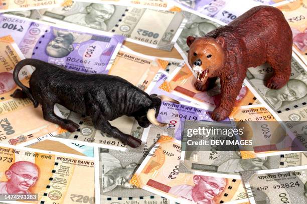 bull and bear figurines on indian currency notes - bull bear stock pictures, royalty-free photos & images