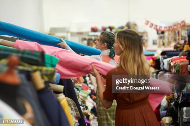 working together in a textile studio - fashion industry stock pictures, royalty-free photos & images