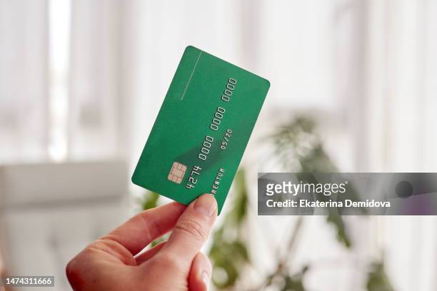 hand holding credit card in hand blurred background - debit card ストックフォトと画像