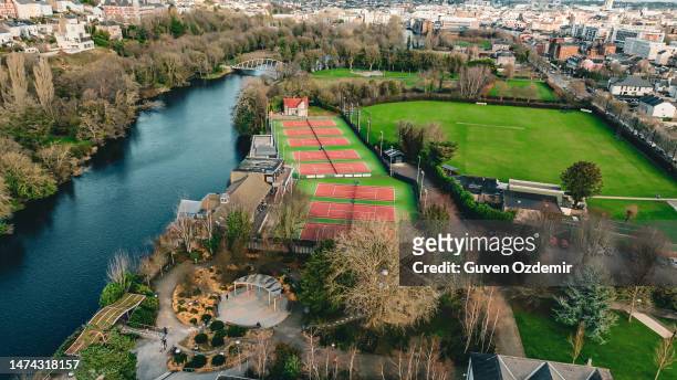 aerial view of people playing tennis, clean tennis courts, tennis courts, people playing tennis, tennis being played on the tennis court, aerial view of tennis courts, sport for health, sport branch - river lee cork stock pictures, royalty-free photos & images