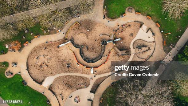 aerial children's amusement park, swings and slides, happy children, children playing in the park and their families, big park in the city,playground in cloudly day, kindergarten, primary school playground background - river lee cork stock pictures, royalty-free photos & images