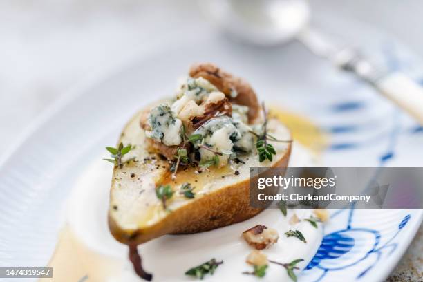 baked pear with blue cheese and walnuts - blue cheese stock pictures, royalty-free photos & images