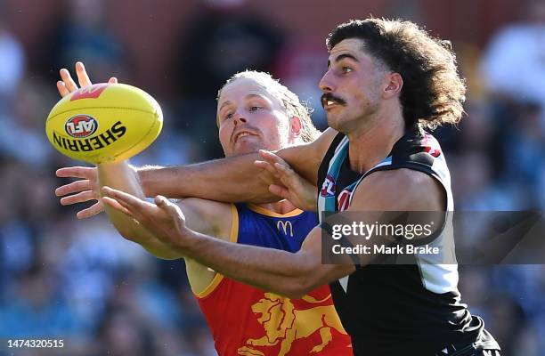 Daniel Rich of the Lions competes with Lachie Jones of Port Adelaide during the round one AFL match between Port Adelaide Power and Brisbane Lions at...