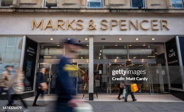 Shoppers pass a branch of the high street retailer Marks & Spencer on March 18, 2023 in Bath, England. Founded in 1884, Marks and Spencer Group plc...