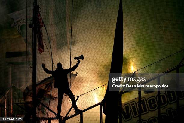 Ultra fan of Werder Bremen is seen in the stands as flares are let off during the Bundesliga match between Borussia Mönchengladbach and SV Werder...