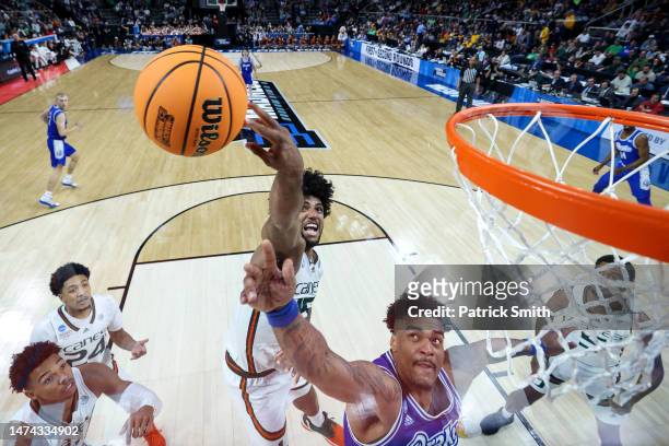 Norchad Omier of the Miami Hurricanes blocks a shot Darnell Brodie of the Drake Bulldogs during the first round of the NCAA Men's Basketball...