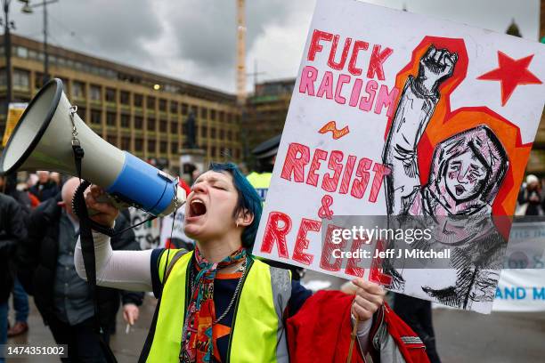 People carry placards as they march during a Stand Up To Racism protest at George Square on March 18, 2023 in Glasgow, Scotland. Given the rise of...