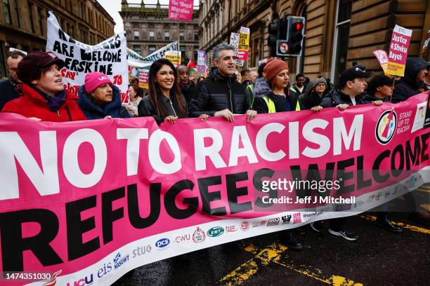 People carry placards as they march during a Stand Up To Racism protest at George Square on March 18, 2023 in Glasgow, Scotland. Given the rise of...