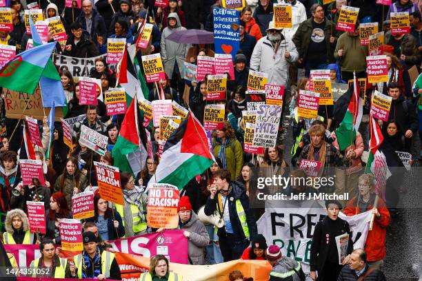 People carry placards as they march during a Stand Up To Racism protest at George Square on March 18, 2023 in Glasgow, Scotland. Given the rise of...