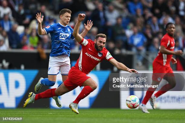 Lucas Tousart of Hertha Berlin is challenged by Dennis Geiger of TSG Hoffenheim during the Bundesliga match between TSG Hoffenheim and Hertha BSC at...