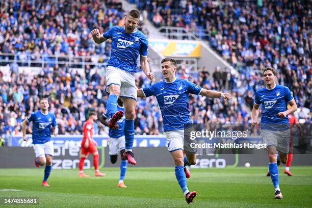 Andrej Kramaric of TSG Hoffenheim celebrates after scoring the team's first goal from a penalty kick with teammates during the Bundesliga match...