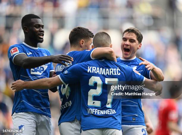Andrej Kramaric of TSG Hoffenheim celebrates after scoring the team's second goal from a penalty kick with teammates during the Bundesliga match...