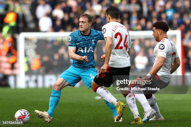 Oliver Skipp of Tottenham Hotspur is put under pressure by Mohamed Elyounoussi and Che Adams of Southampton during the Premier League match between...