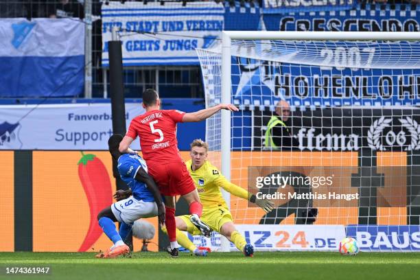 Ihlas Bebou of TSG Hoffenheim scores the team's third goal as Oliver Christensen of Hertha Berlin attmepts to make a save during the Bundesliga match...