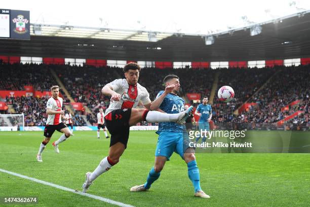 Che Adams of Southampton passes the ball while under pressure from Clement Lenglet of Tottenham Hotspur during the Premier League match between...