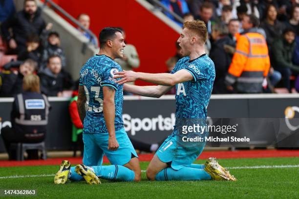 Pedro Porro of Tottenham Hotspur celebrates with teammate Dejan Kulusevski after scoring the team's first goal during the Premier League match...