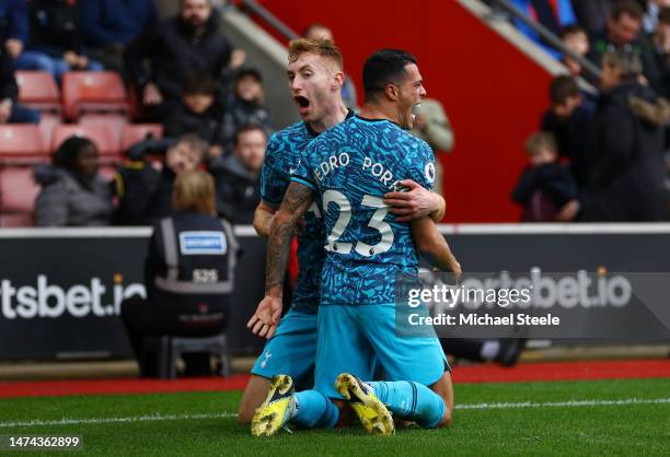 Pedro Porro of Tottenham Hotspur celebrates with teammate Dejan Kulusevski after scoring the team's first goal during the Premier League match...