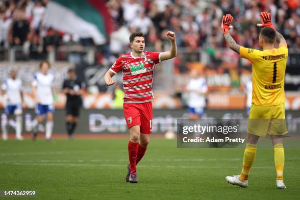 Elvis Rexhbecaj and Rafal Gikiewicz of FC Augsburg celebrate after Arne Maier scores the team's first goal during the Bundesliga match between FC...