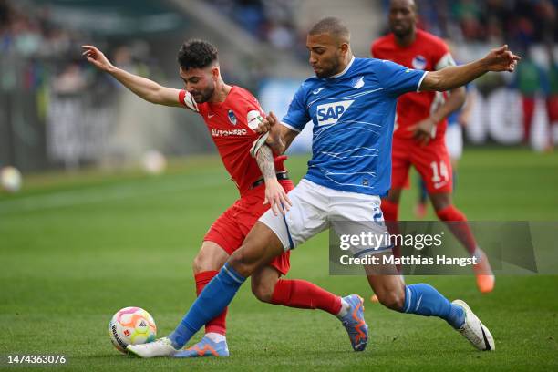 Marco Richter of Hertha Berlin is challenged by Kevin Akpoguma of TSG Hoffenheim during the Bundesliga match between TSG Hoffenheim and Hertha BSC at...