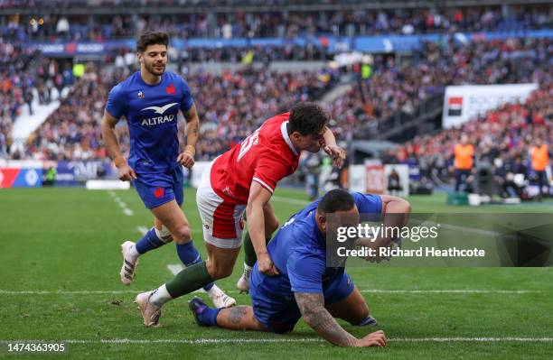 Uini Atonio of France scores their side's third try whilst under pressure from Louis Rees-Zammit of Wales during the Six Nations Rugby match between...