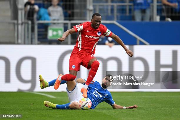Dodi Lukebakio of Hertha Berlin is fouled by Munas Dabbur of TSG Hoffenheim, before Munas Dabbur receives a red card, during the Bundesliga match...