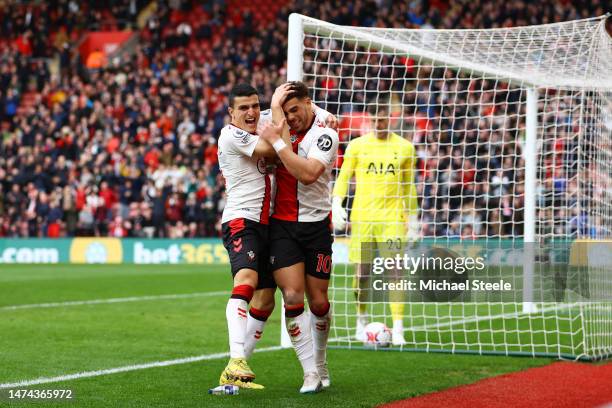 Che Adams of Southampton celebrates with teammate Mohamed Elyounoussi after scoring the team's first goal during the Premier League match between...