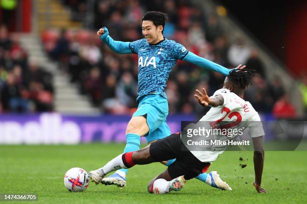 Son Heung-Min of Tottenham Hotspur battles for possession with Mohammed Salisu of Southampton during the Premier League match between Southampton FC...