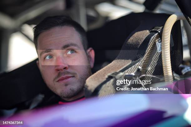 Alex Bowman, driver of the Ally Chevrolet, sits in his car during qualifying for the NASCAR Cup Series Ambetter Health 400 at Atlanta Motor Speedway...