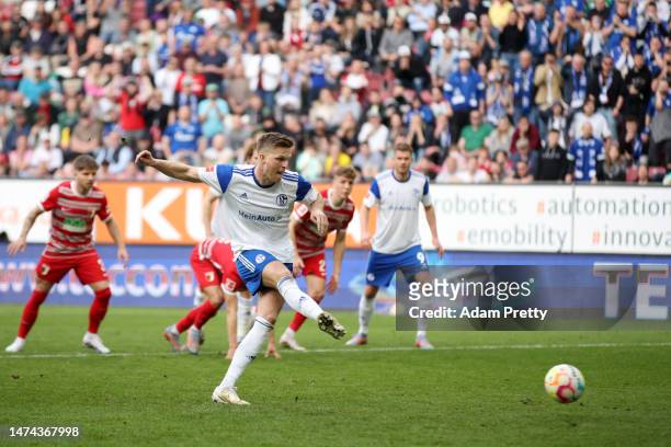Marius Buelter of FC Schalke 04 scores the team's first goal from the penalty spot during the Bundesliga match between FC Augsburg and FC Schalke 04...