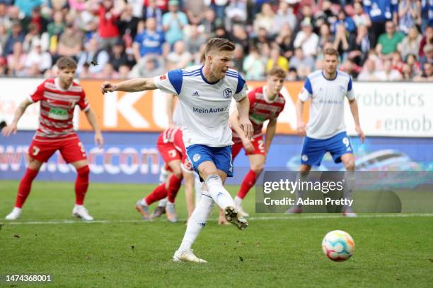 Marius Buelter of FC Schalke 04 scores the team's first goal from the penalty spot during the Bundesliga match between FC Augsburg and FC Schalke 04...