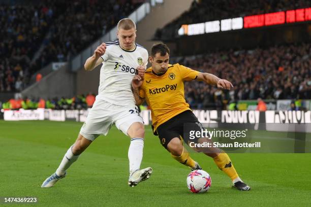 Jonny of Wolverhampton Wanderers is challenged by Rasmus Kristensen of Leeds United during the Premier League match between Wolverhampton Wanderers...