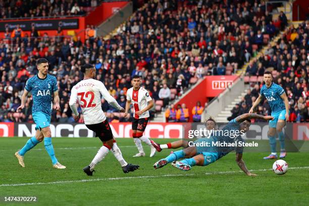 Theo Walcott of Southampton scores the team's second goal past Cristian Romero of Tottenham Hotspur during the Premier League match between...