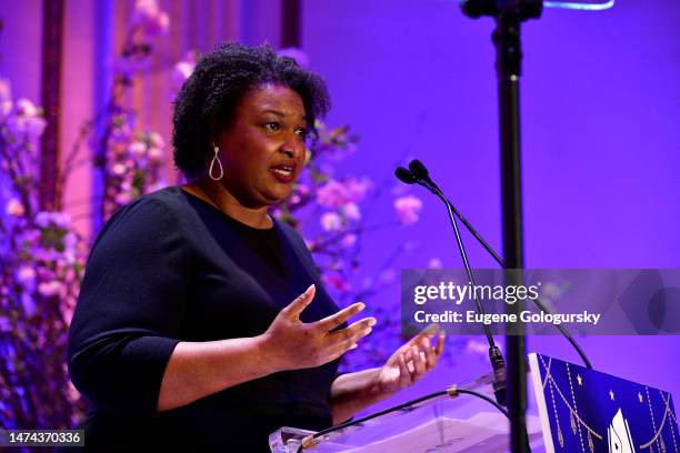 Elevating Equity Honoree Stacey Abrams speaks on stage as Phoebe Robinson emcees Reading Partners' Dream Dinner Party honoring Stacey Abrams &...