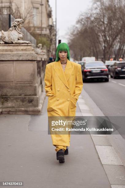 Alyy Space with green hair is seen wearing a yellow coat and matching pants outside the Louis Vuitton show during Paris Fashion Week - Womenswear...