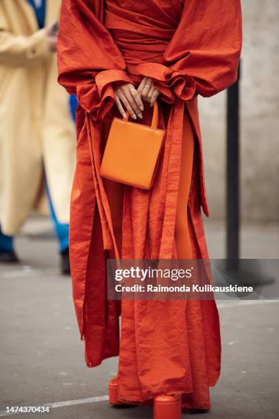 Sarah Monteil is seen wearing orange tights, wraped skirt, matching sirt, orange patform shoes and orange bag outside the Shiatzy Chen show during...