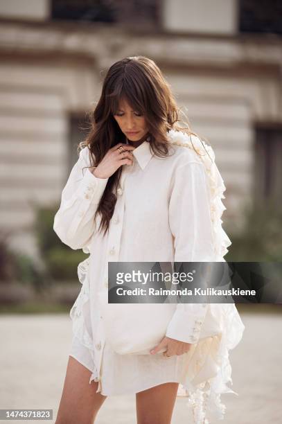 Alison Toby is seen wearing a white blouse dress, a white bag and beige high boots outside the Zimmermann show during Paris Fashion Week - Womenswear...