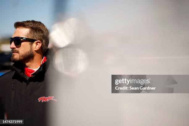 Yeley, driver of the Barnett Southern Corporation Ford, looks on during qualifying for the NASCAR Cup Series Ambetter Health 400 at Atlanta Motor...