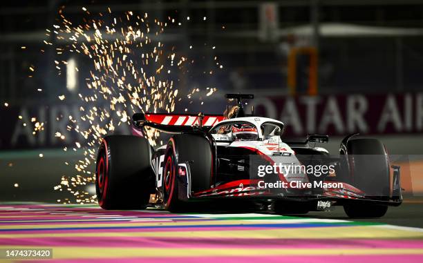 Sparks fly behind Kevin Magnussen of Denmark driving the Haas F1 VF-23 Ferrari during qualifying ahead of the F1 Grand Prix of Saudi Arabia at Jeddah...