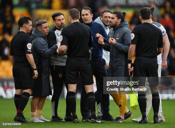 Julen Lopetegui, Manager of Wolverhampton Wanderers and Ruben Neves clash with Referee Michael Salisbury after the team's defeat in the Premier...