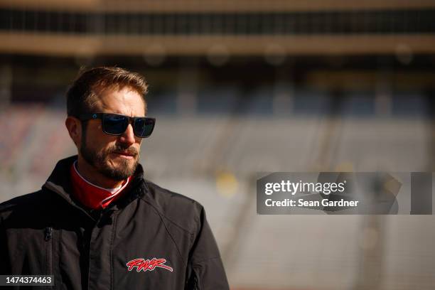 Yeley, driver of the Barnett Southern Corporation Ford, looks on during qualifying for the NASCAR Cup Series Ambetter Health 400 at Atlanta Motor...